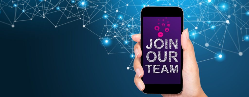 Join our team concept. Join our team on smartphone screen in businesswoman hand.
